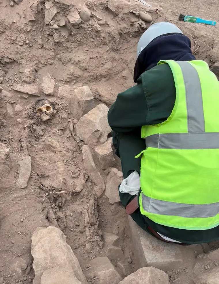 An archaeologist engages in meticulous excavation work at a pre-Hispanic burial site in Lima, Peru, alongside a mummy suspected to be associated with the Manchay culture. This culture, flourishing between 1,500 and 1,000 BCE, gradually reveals its secrets through the diligent efforts of dedicated researchers.